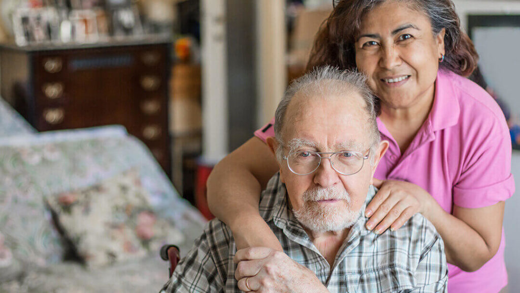 Senior Living Worker Retention - daughter hugs senior father