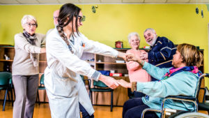 Group of seniors dancing at a nursing home with nurse