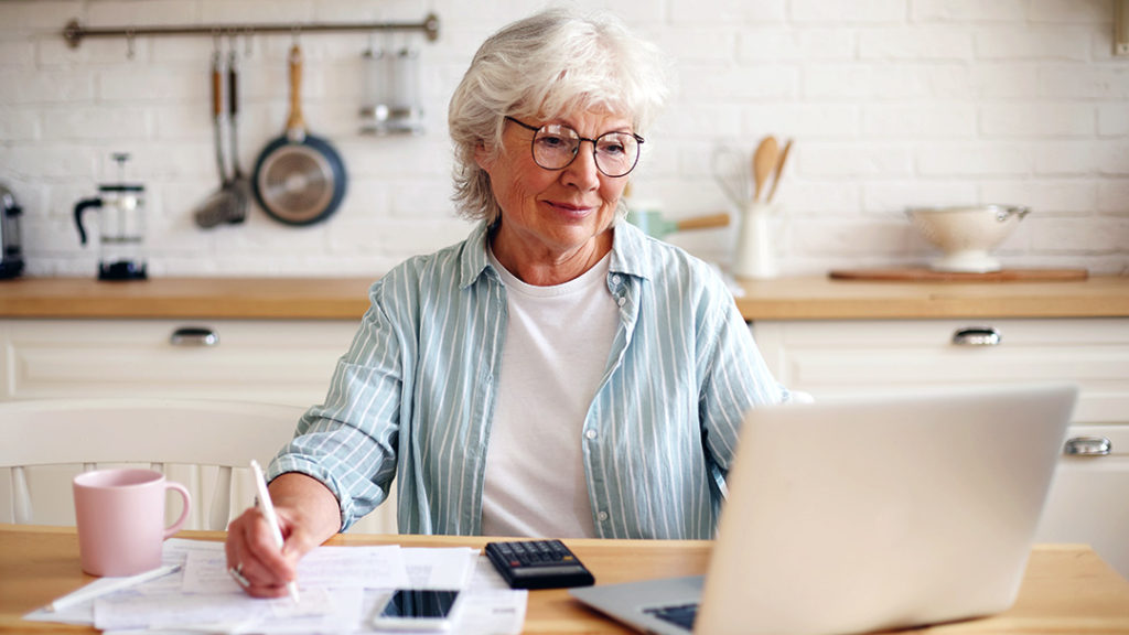 Senior woman assessing finances to pay for elder care